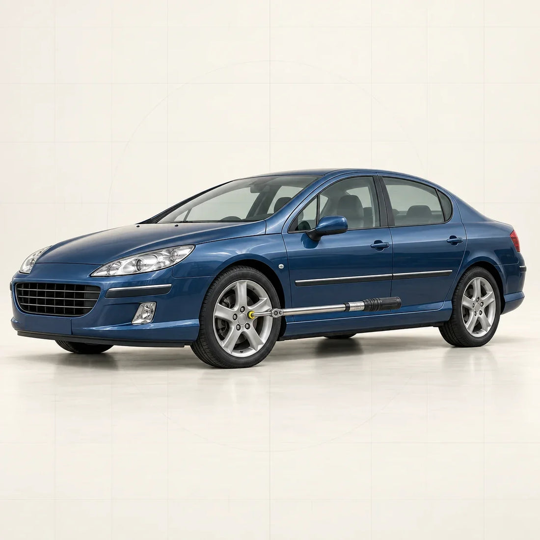 Peugeot 407 bleue avec une clé dynamométrique engagée sur une vis de roue avant
