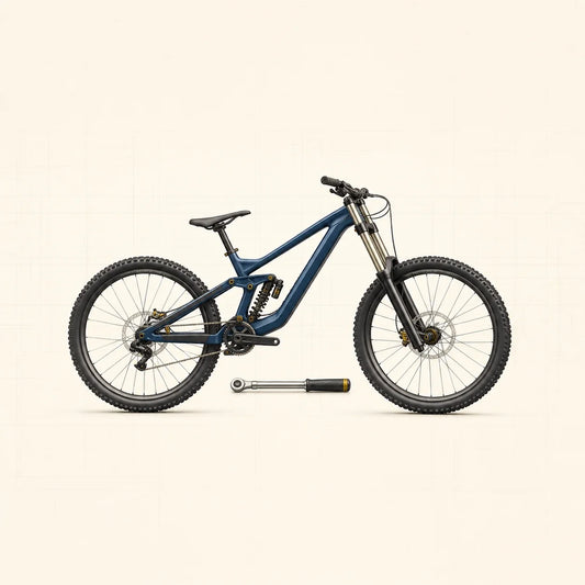 VTT de descente bleu avec points de fixation jaunes et clé dynamométrique au sol